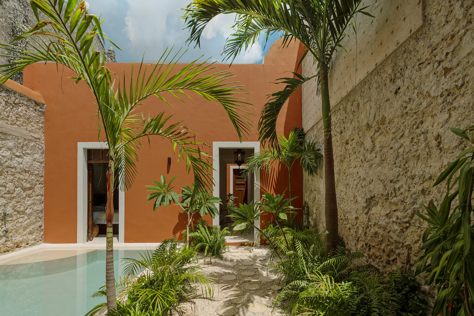 Casa Ex Templo, a former convent annex — interior courtyard with palm and arcade — Casonas MX, Campeche